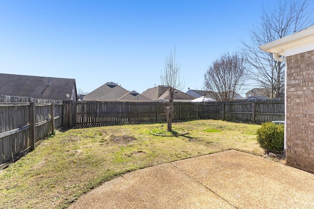 view of yard featuring a patio area and a fenced backyard