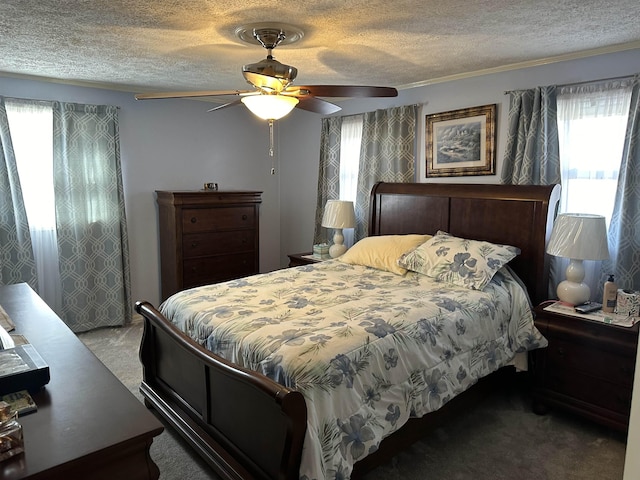 carpeted bedroom with ceiling fan, ornamental molding, and a textured ceiling