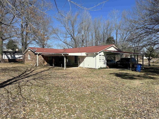 exterior space with an attached carport, a lawn, and driveway