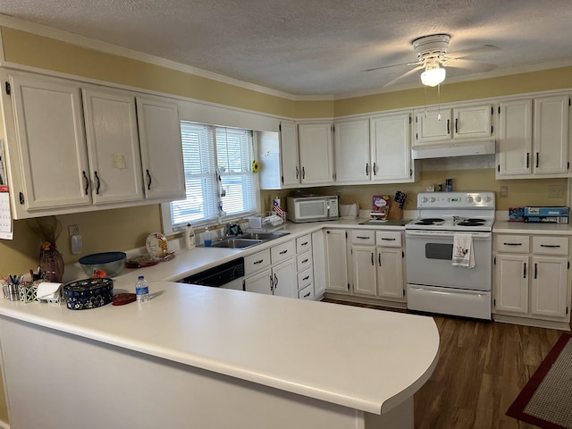 kitchen with white appliances, white cabinets, dark wood finished floors, and under cabinet range hood