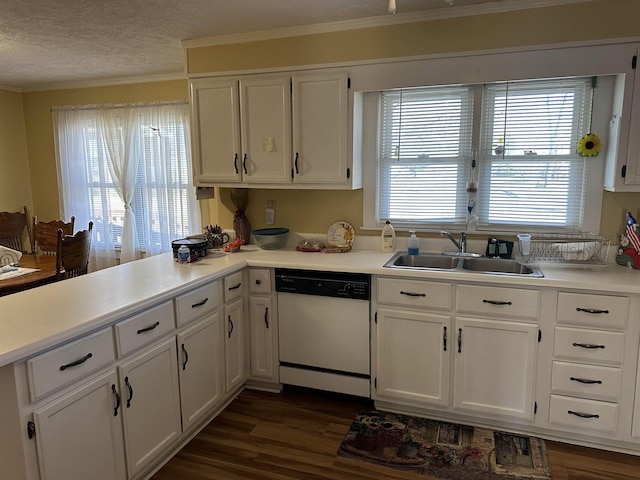 kitchen featuring dark wood-style flooring, light countertops, white cabinets, white dishwasher, and a sink