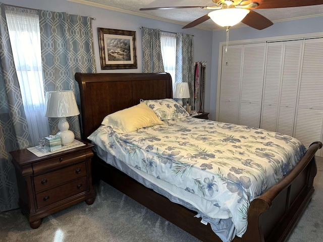 bedroom with carpet floors, ornamental molding, a closet, and a ceiling fan