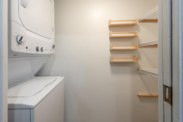 washroom with stacked washer and dryer and laundry area