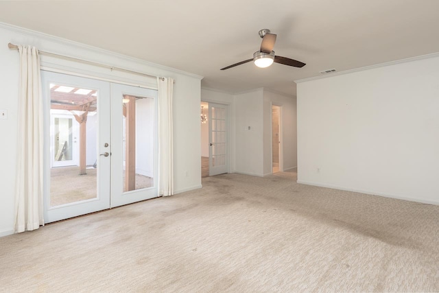 spare room featuring carpet floors, visible vents, baseboards, french doors, and crown molding