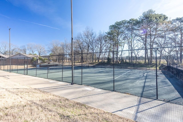 view of sport court featuring fence