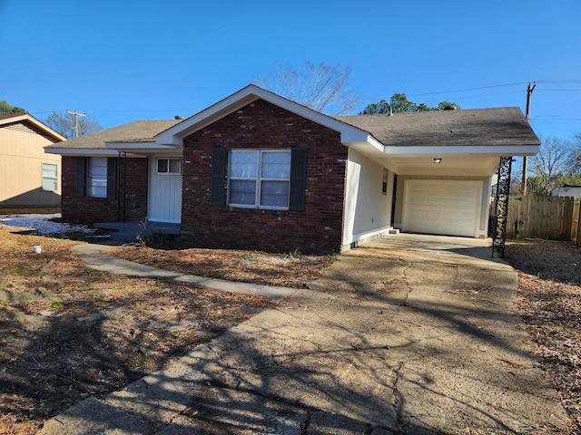 single story home with concrete driveway, brick siding, an attached garage, and fence