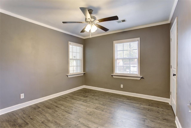 unfurnished room featuring crown molding, visible vents, and a wealth of natural light