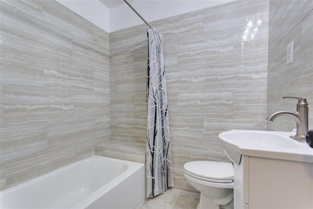 bathroom featuring tile patterned flooring, toilet, vanity, tile walls, and shower / bath combination with curtain