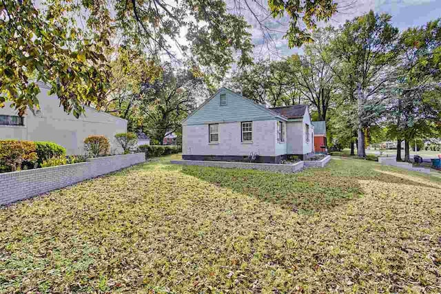 view of side of home featuring a yard