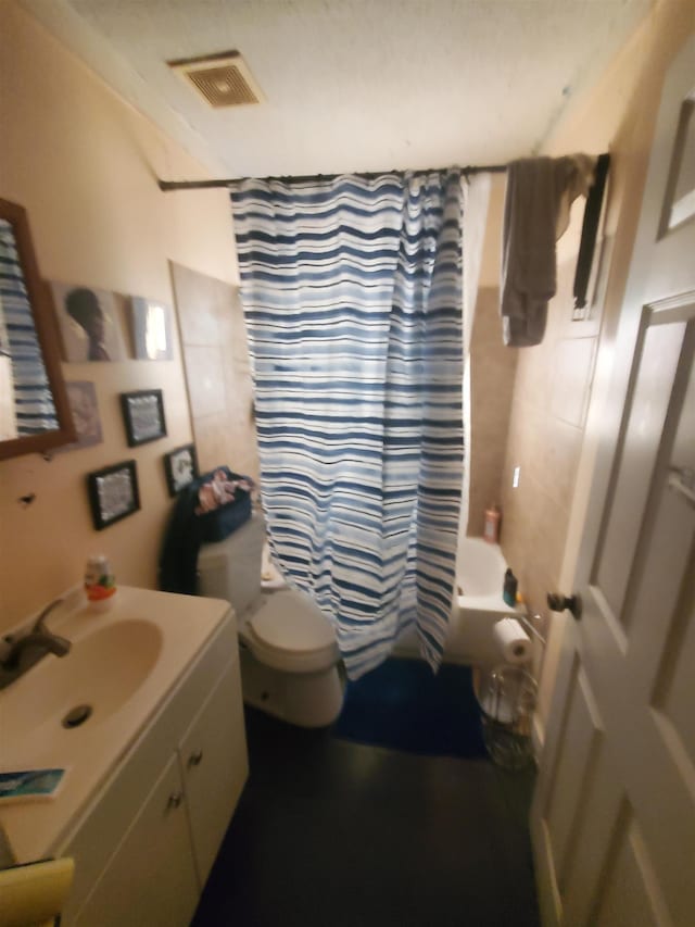 bathroom featuring toilet, vanity, visible vents, and shower / bathtub combination with curtain