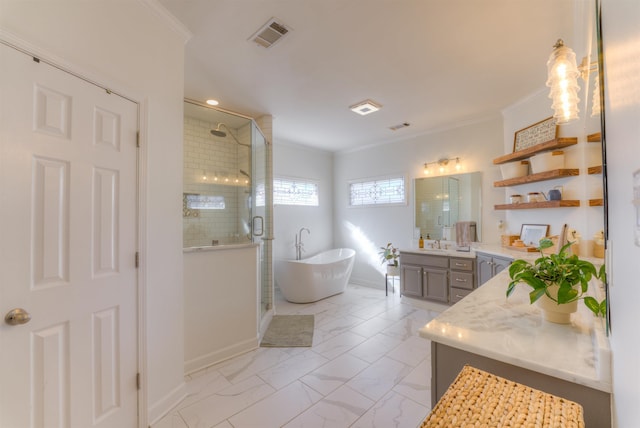 bathroom featuring marble finish floor, ornamental molding, a freestanding tub, and a stall shower