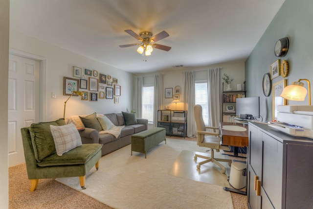 living area featuring ceiling fan and light colored carpet