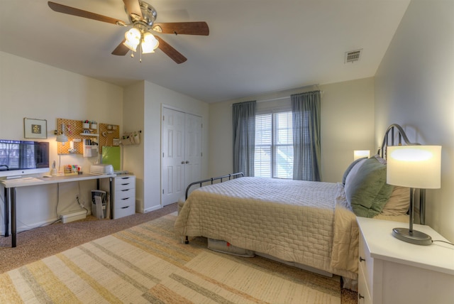 carpeted bedroom featuring a closet, visible vents, and a ceiling fan