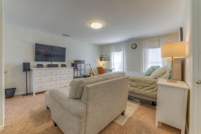 bedroom with light carpet, baseboards, and visible vents