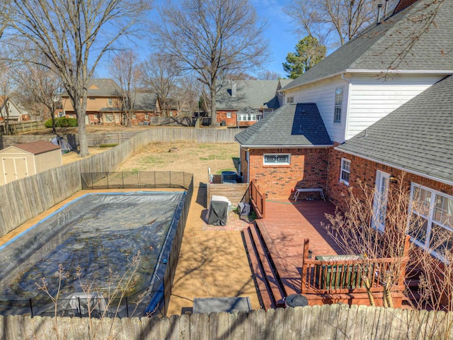 view of pool featuring a fenced backyard, a deck, and a yard