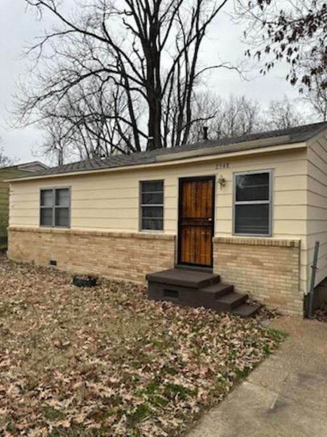 view of front facade with crawl space and brick siding