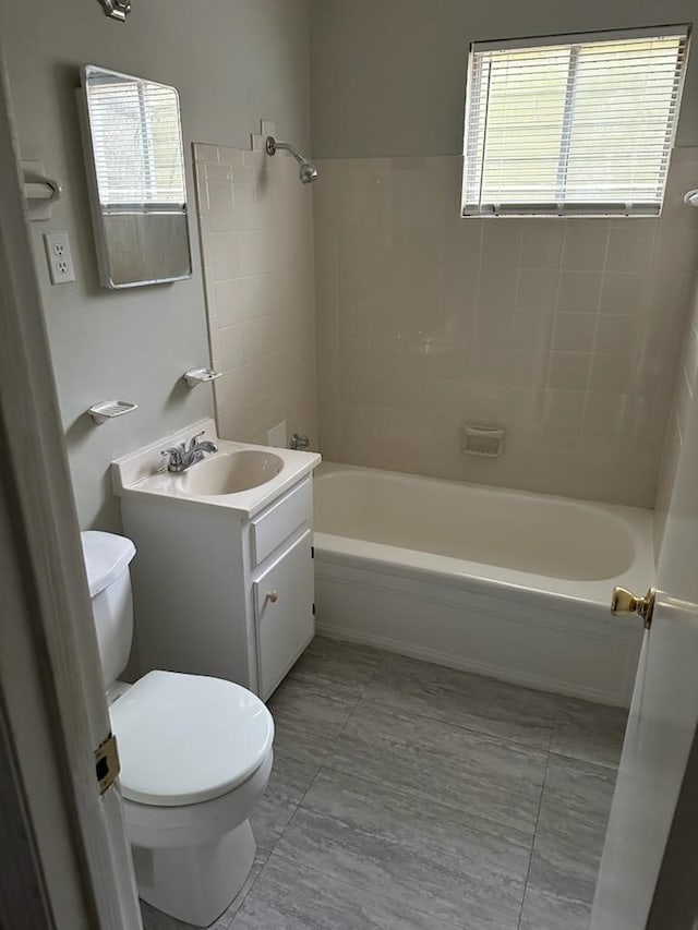 full bathroom featuring toilet, bathtub / shower combination, and vanity