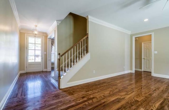 entryway featuring ornamental molding, stairs, baseboards, and wood finished floors