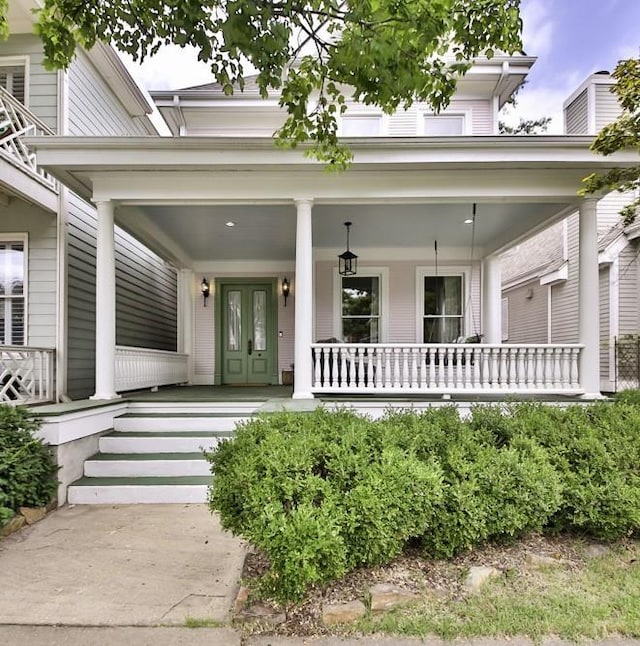 view of exterior entry with covered porch