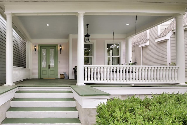 view of exterior entry featuring a porch