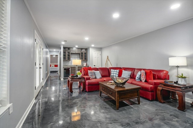 living room with wine cooler, finished concrete flooring, recessed lighting, ornamental molding, and baseboards