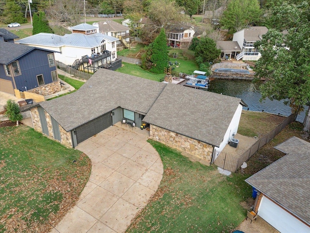 birds eye view of property featuring a water view and a residential view