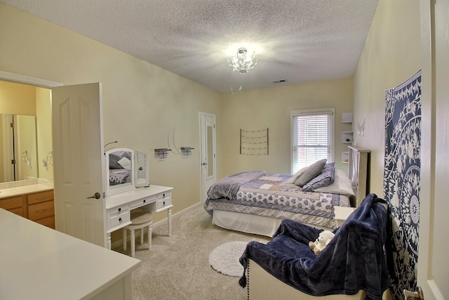 bedroom with visible vents, a textured ceiling, and light colored carpet