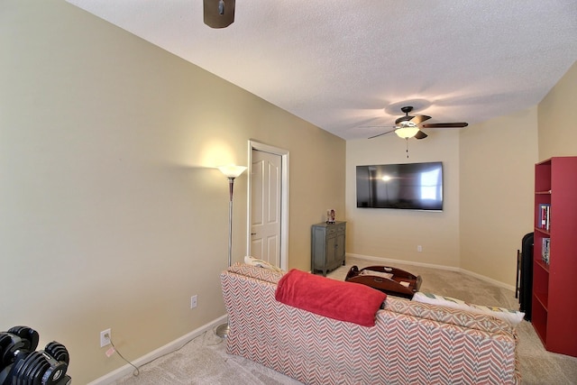 bedroom with light carpet, ceiling fan, a textured ceiling, and baseboards