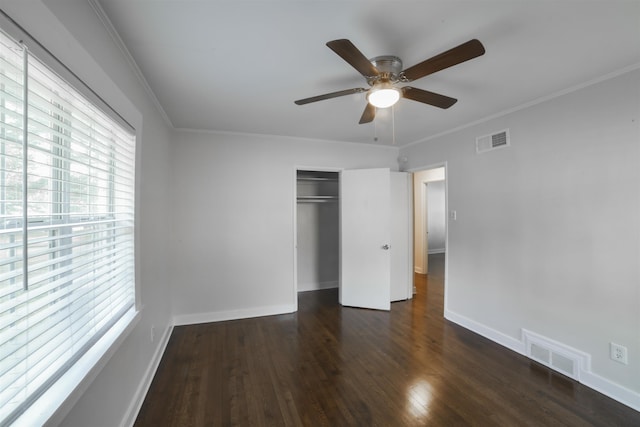 unfurnished bedroom featuring baseboards, visible vents, and wood finished floors