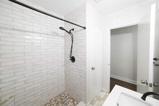 full bathroom with a stall shower, baseboards, and ornamental molding