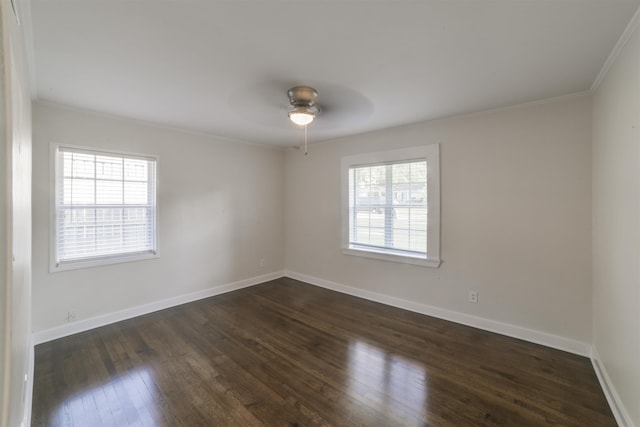 unfurnished room featuring dark wood-style floors, plenty of natural light, and baseboards