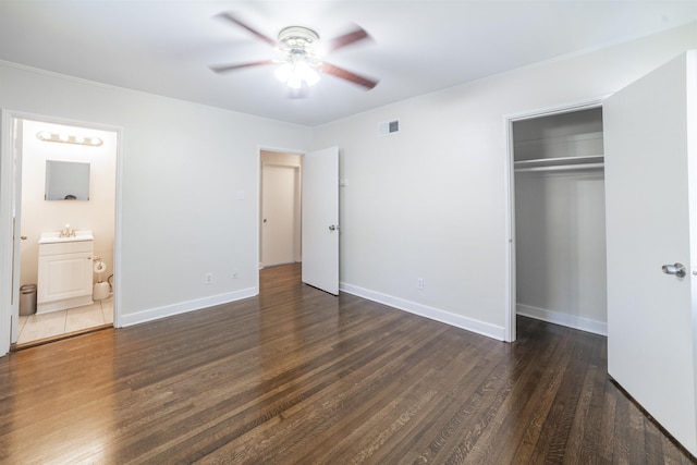 unfurnished bedroom with baseboards, a closet, visible vents, and wood finished floors