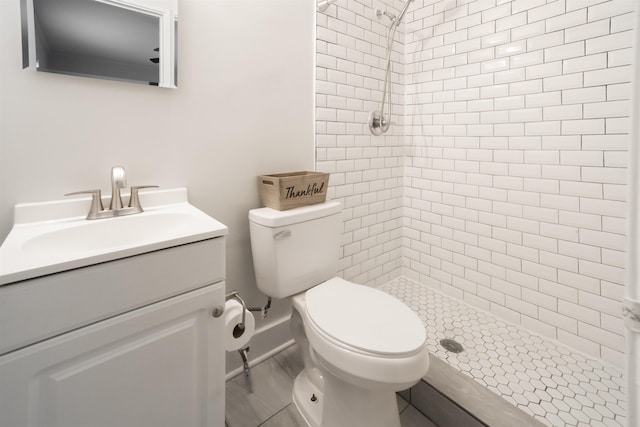 full bathroom with a stall shower, vanity, and toilet