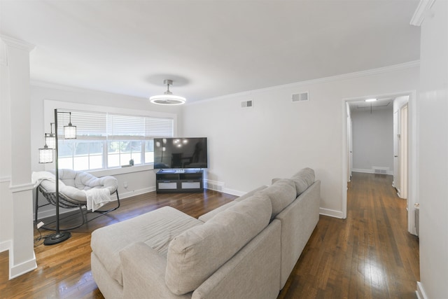 living room with ornamental molding, dark wood-style flooring, visible vents, and attic access