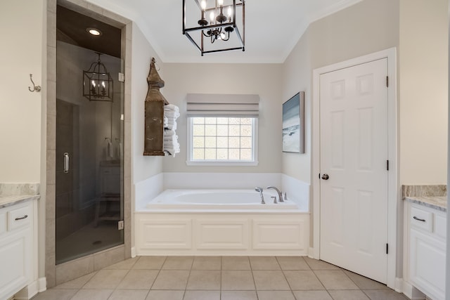 bathroom featuring a stall shower, a bath, tile patterned flooring, vanity, and a notable chandelier