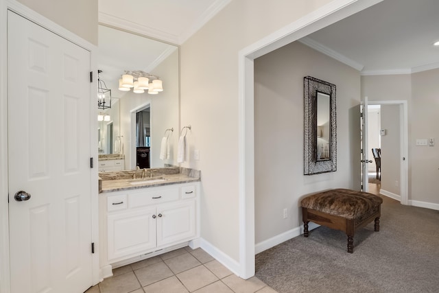 bathroom featuring ornamental molding, tile patterned flooring, vanity, and baseboards