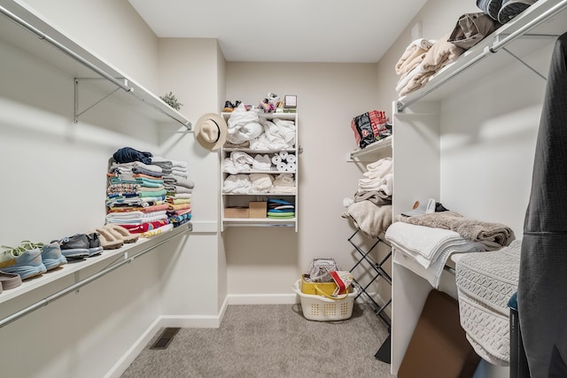 walk in closet featuring carpet flooring and visible vents