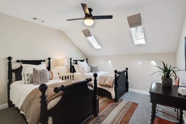 bedroom featuring lofted ceiling with skylight, carpet, visible vents, and baseboards