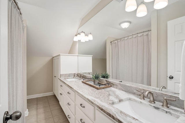 full bath with lofted ceiling, double vanity, tile patterned flooring, and a sink