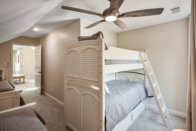 carpeted bedroom with lofted ceiling, ceiling fan, visible vents, and baseboards