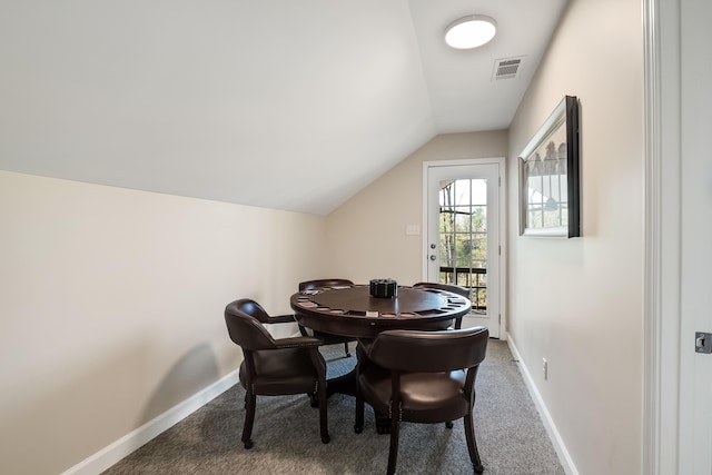 dining room with lofted ceiling, carpet flooring, visible vents, and baseboards