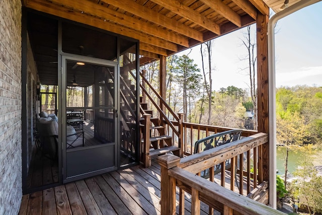 wooden terrace with stairway and a water view