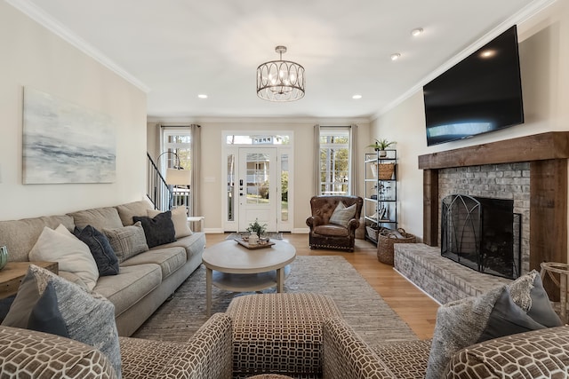 living area with ornamental molding, plenty of natural light, and wood finished floors