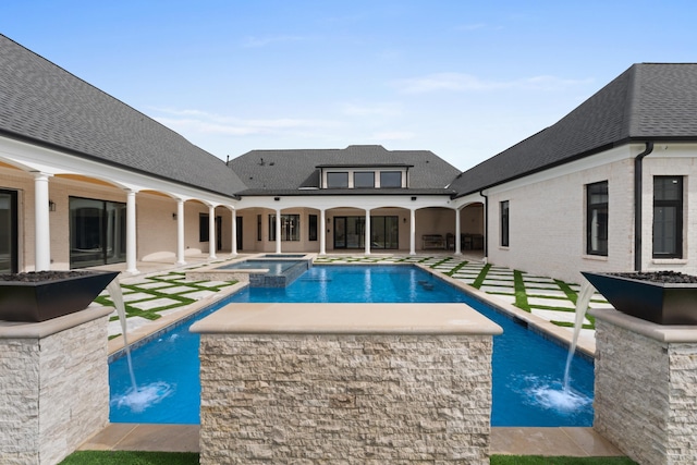 view of swimming pool with a pool with connected hot tub and a patio