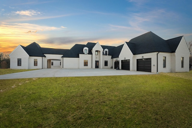 view of front of home with a garage, driveway, and a front lawn