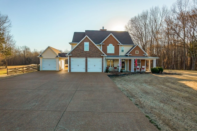 view of front facade featuring a porch, concrete driveway, an attached garage, fence, and a front lawn