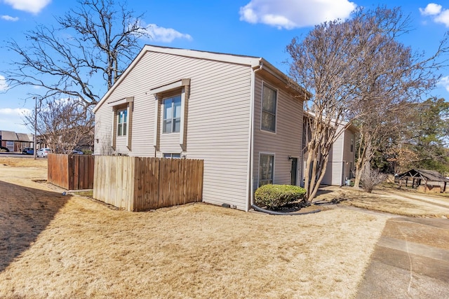 view of home's exterior with fence