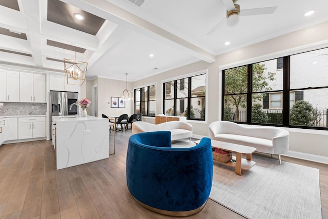 living room featuring hardwood / wood-style flooring, beamed ceiling, and recessed lighting