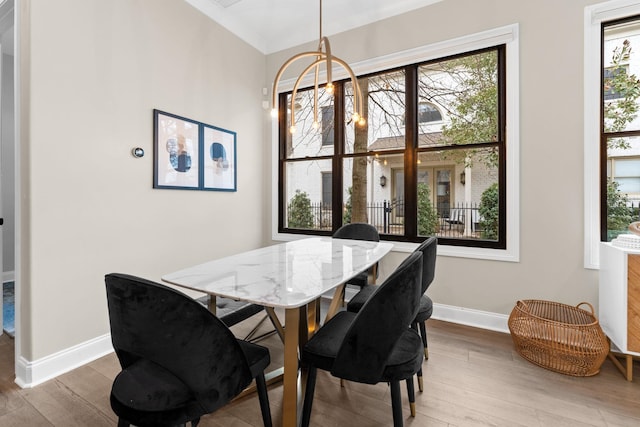 dining area with baseboards and wood finished floors