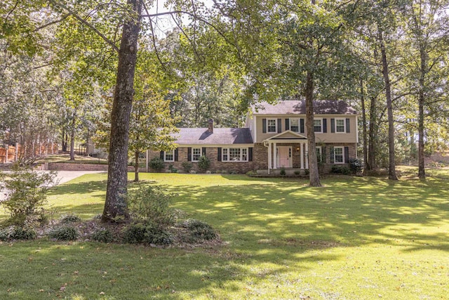 colonial house with a chimney and a front lawn